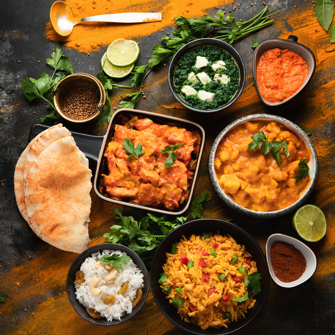 A cheeseburger on a wooden cutting board with ketchup.